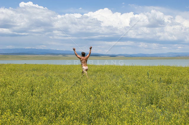 naked-man-running-through-a-field-of-wildflowers-by-a-lake-in-New-Mexico_zpsiojedhbc.jpg