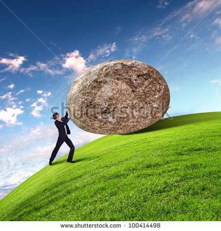 stock-photo-image-of-businessman-rolling-a-giant-stone-100414498.jpg